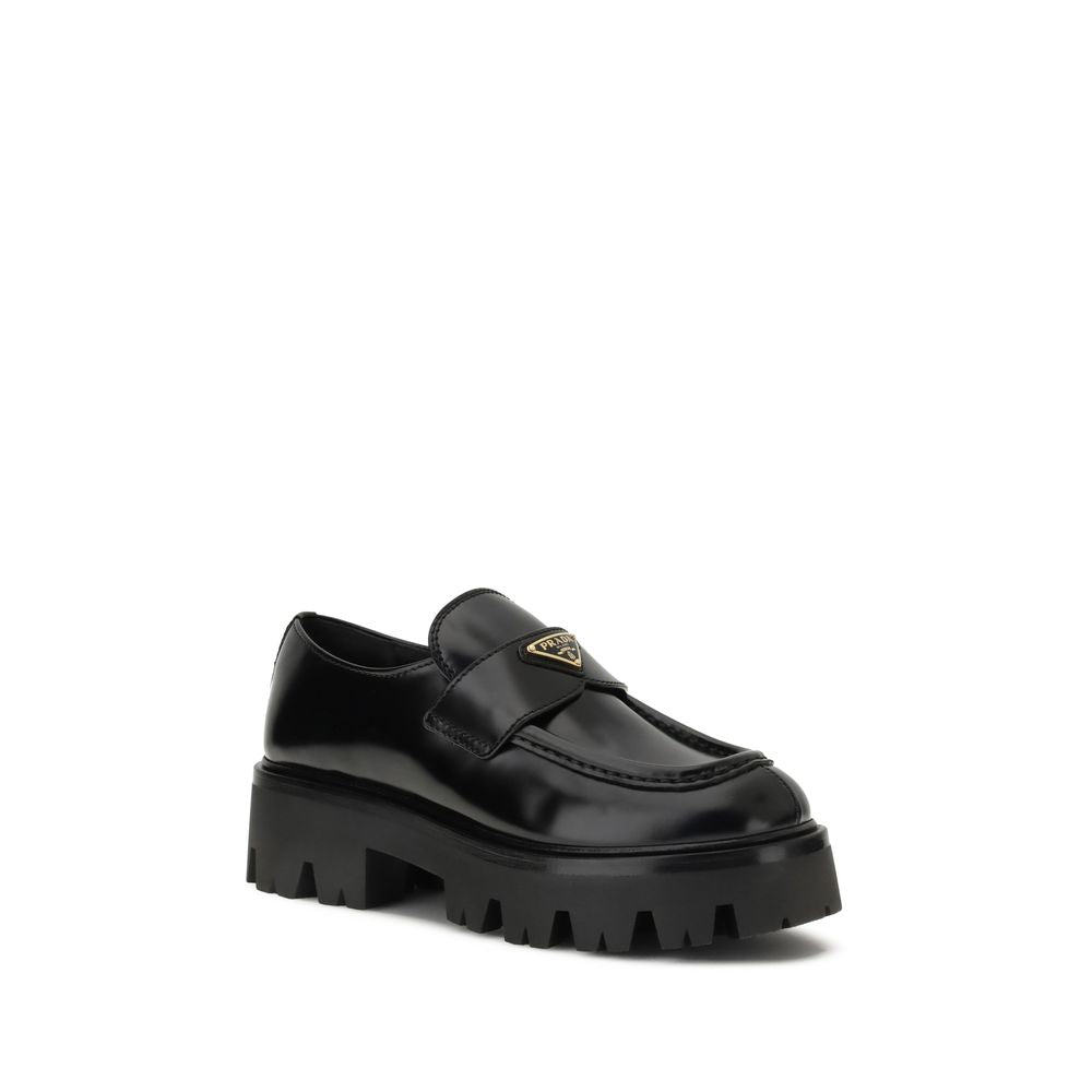 Black Calf Leather Bos Taurus Platform LoafersBrushed leather Monolith Loafers by Prada reinterpret a classic with a bold, contemporary twist. Featuring a leather horsebit upper with metallic detail, they have a burlotto bowl and an all-leather lining. Th
