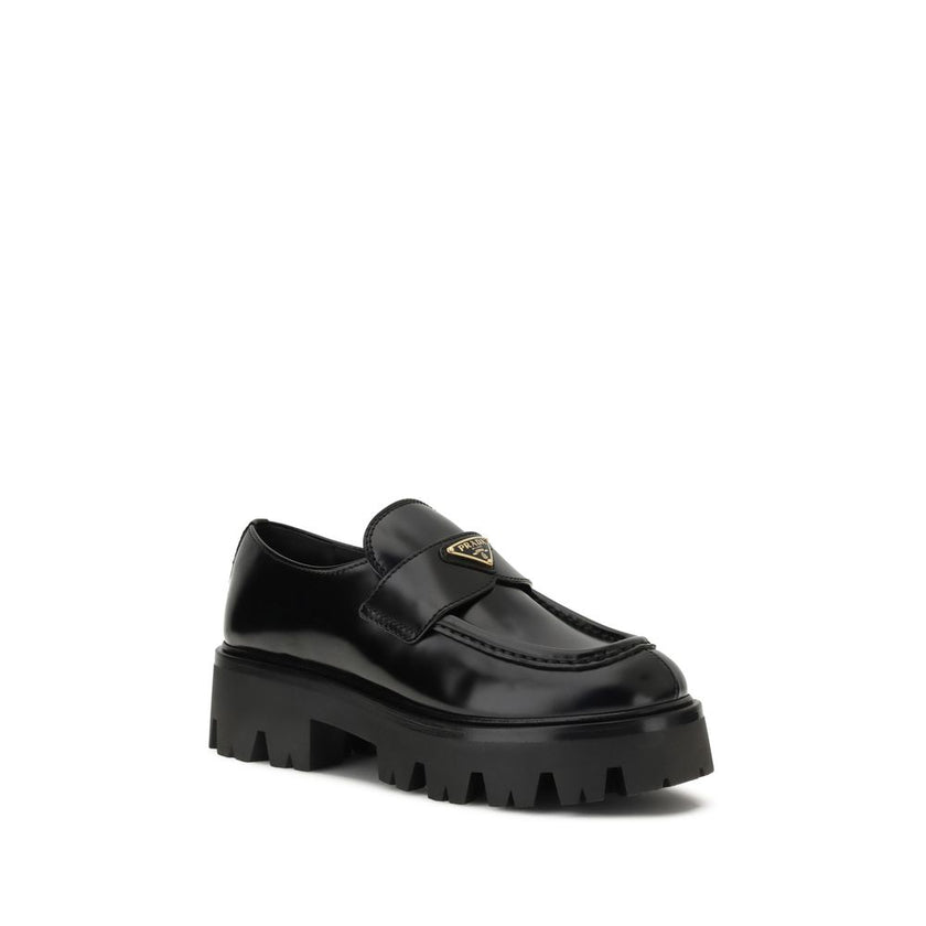 Black Calf Leather Bos Taurus Platform LoafersBrushed leather Monolith Loafers by Prada reinterpret a classic with a bold, contemporary twist. Featuring a leather horsebit upper with metallic detail, they have a burlotto bowl and an all-leather lining. Th