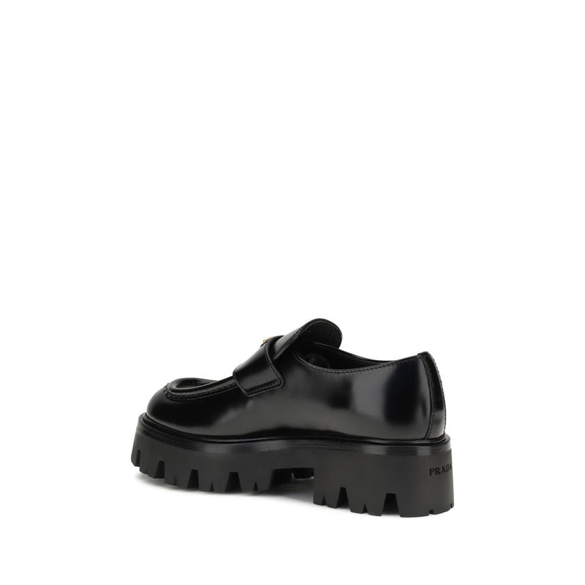 Black Calf Leather Bos Taurus Platform LoafersBrushed leather Monolith Loafers by Prada reinterpret a classic with a bold, contemporary twist. Featuring a leather horsebit upper with metallic detail, they have a burlotto bowl and an all-leather lining. Th