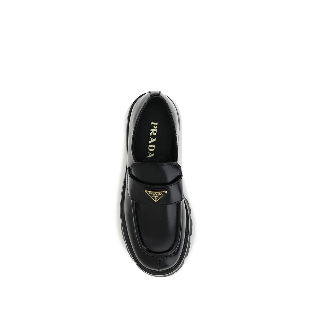 Black Calf Leather Bos Taurus Platform LoafersBrushed leather Monolith Loafers by Prada reinterpret a classic with a bold, contemporary twist. Featuring a leather horsebit upper with metallic detail, they have a burlotto bowl and an all-leather lining. Th