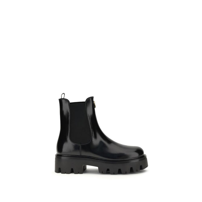 Black Rubber Ankle BootsThe brushed leather Ankle Boots by Prada combine sophistication with bold character. The upper features elasticated side inserts and a rear pull tab, while the leather lining ensures comfort and artisanal quality. The iconic enamel