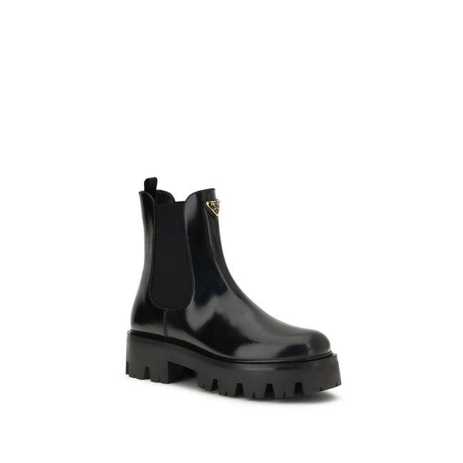 Black Rubber Ankle BootsThe brushed leather Ankle Boots by Prada combine sophistication with bold character. The upper features elasticated side inserts and a rear pull tab, while the leather lining ensures comfort and artisanal quality. The iconic enamel