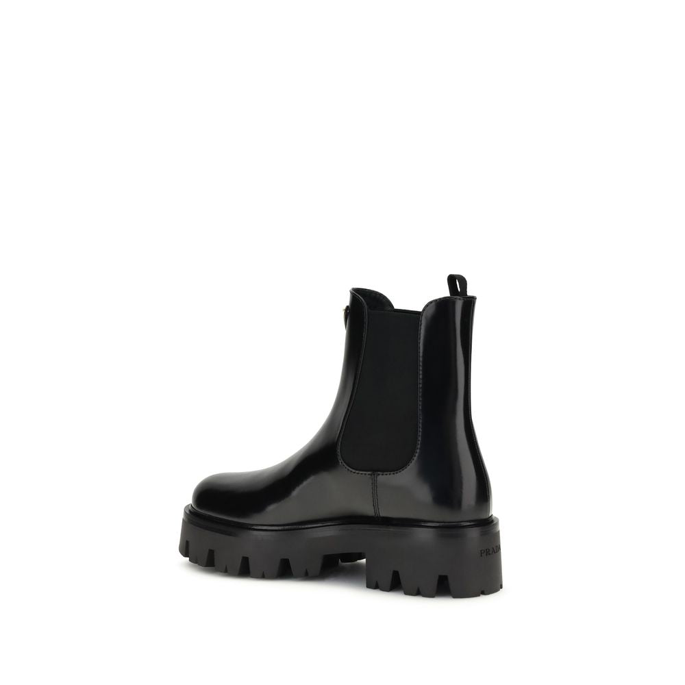 Black Rubber Ankle BootsThe brushed leather Ankle Boots by Prada combine sophistication with bold character. The upper features elasticated side inserts and a rear pull tab, while the leather lining ensures comfort and artisanal quality. The iconic enamel
