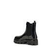 Black Rubber Ankle BootsThe brushed leather Ankle Boots by Prada combine sophistication with bold character. The upper features elasticated side inserts and a rear pull tab, while the leather lining ensures comfort and artisanal quality. The iconic enamel