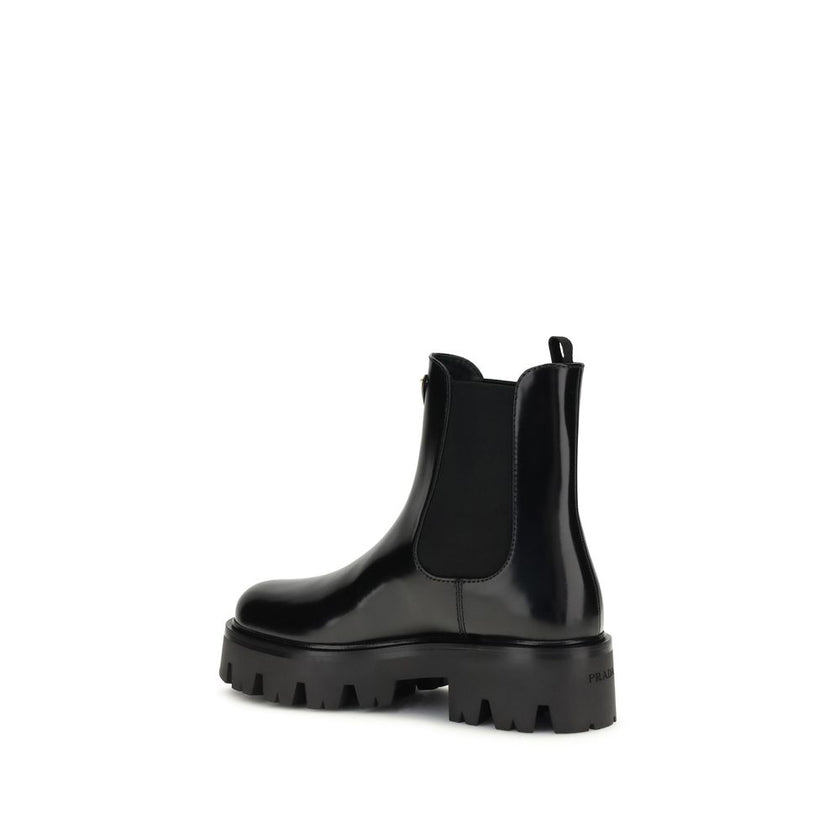 Black Rubber Ankle BootsThe brushed leather Ankle Boots by Prada combine sophistication with bold character. The upper features elasticated side inserts and a rear pull tab, while the leather lining ensures comfort and artisanal quality. The iconic enamel