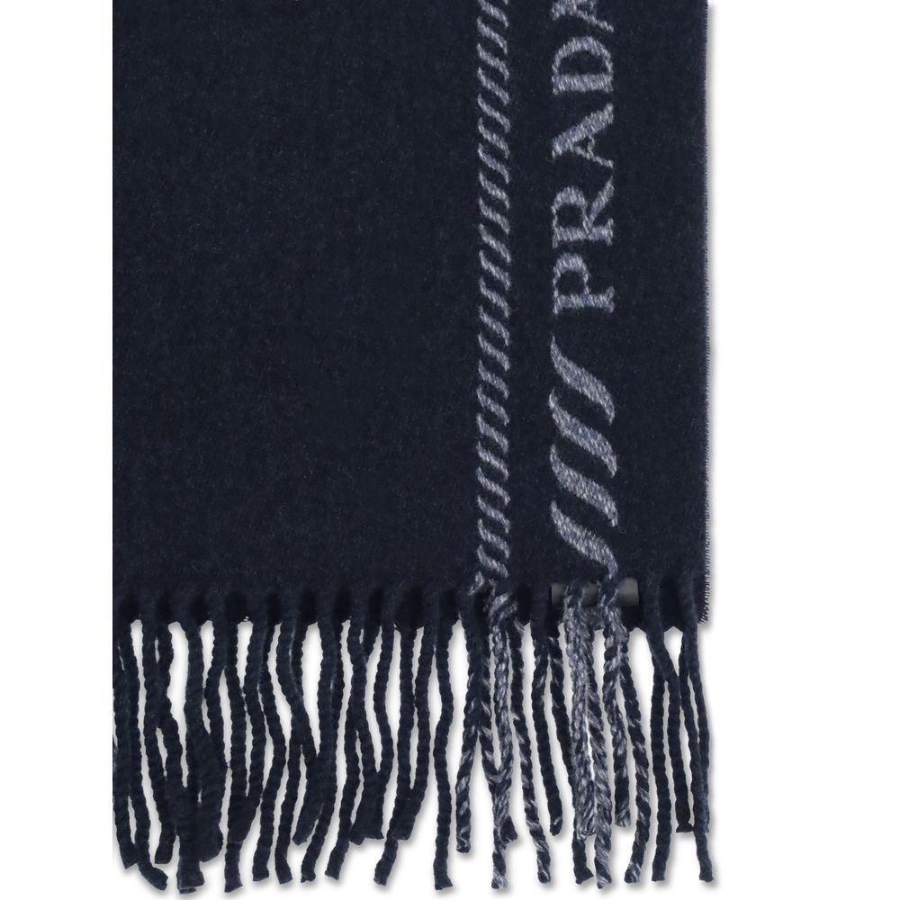 Blue Fleece Wool ScarfThe virgin wool and cashmere Scarf by Prada is an elegant and versatile accessory. Crafted from soft blue virgin wool and cashmere, it is enriched with a refined grey striped pattern and logo inlay along the edges. Fringed hems add a
