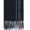 Blue Fleece Wool ScarfThe virgin wool and cashmere Scarf by Prada is an elegant and versatile accessory. Crafted from soft blue virgin wool and cashmere, it is enriched with a refined grey striped pattern and logo inlay along the edges. Fringed hems add a