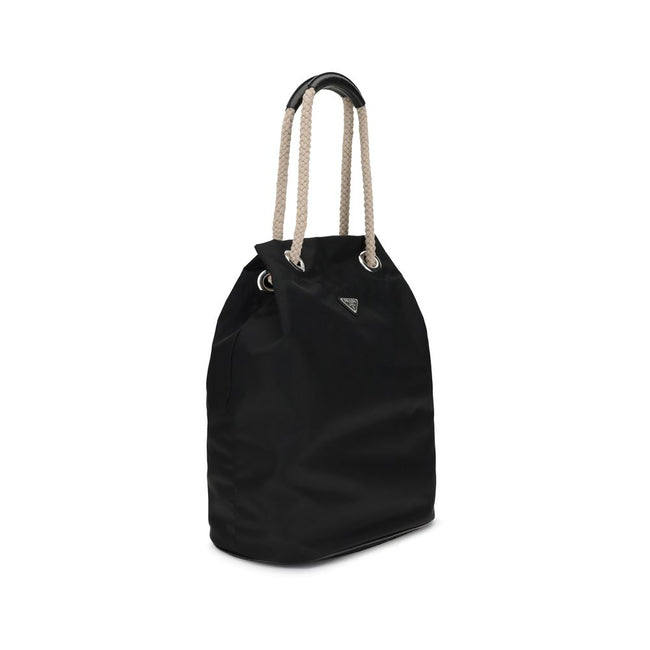 Black Recycled Polyamide Shoulder BagMedium Mariner Re-Nylon Bucket Bag by Prada combines functional design and sustainable materials. The soft, roomy silhouette is enhanced by rope and leather sliding handles that contrast with the technical texture of R