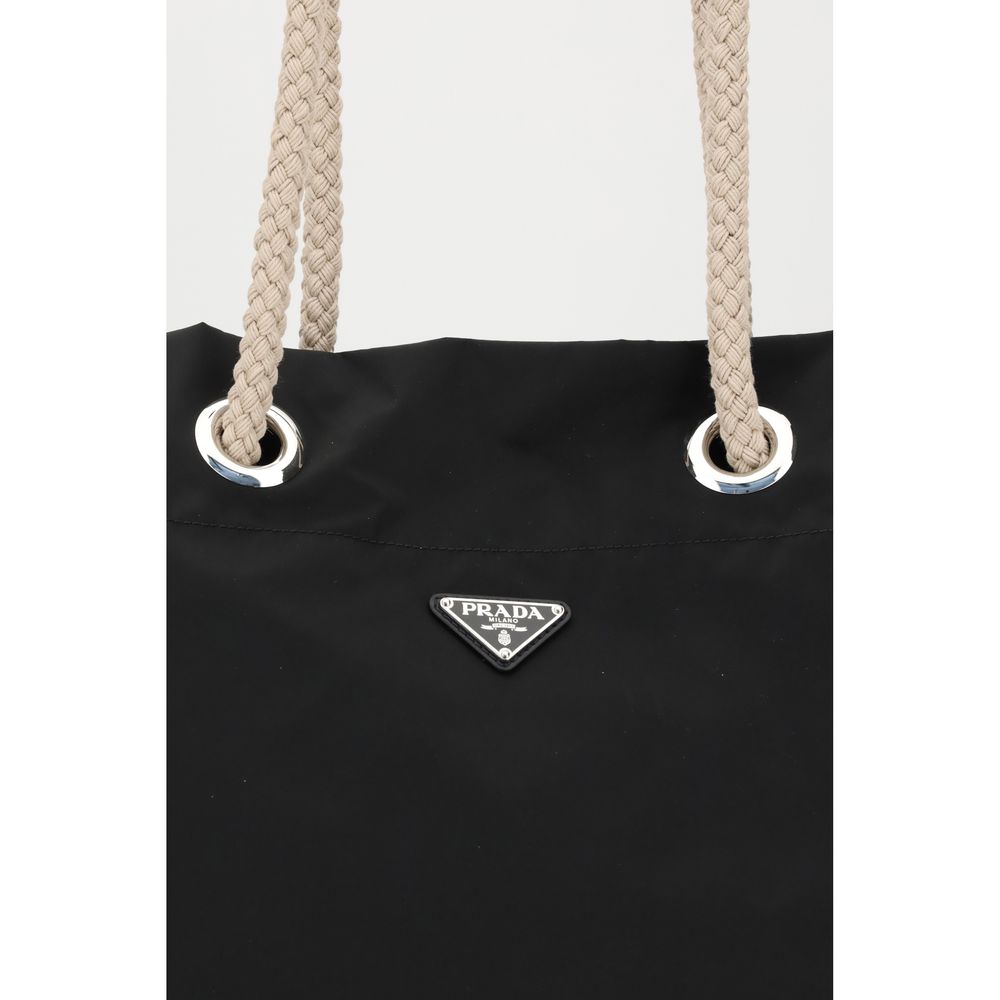 Black Recycled Polyamide Shoulder BagMedium Mariner Re-Nylon Bucket Bag by Prada combines functional design and sustainable materials. The soft, roomy silhouette is enhanced by rope and leather sliding handles that contrast with the technical texture of R