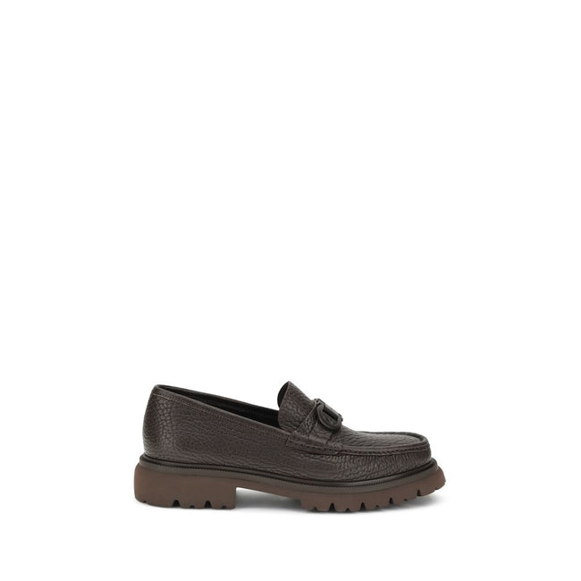 Brown Calf Leather Bos Taurus Slip-On LoafersGancini Loafers by Ferragamo combine craftsmanship and contemporary style. Crafted from washed calfskin, which highlights the natural grain, they feature a rounded toe and an exposed stitching. The tonal buckle