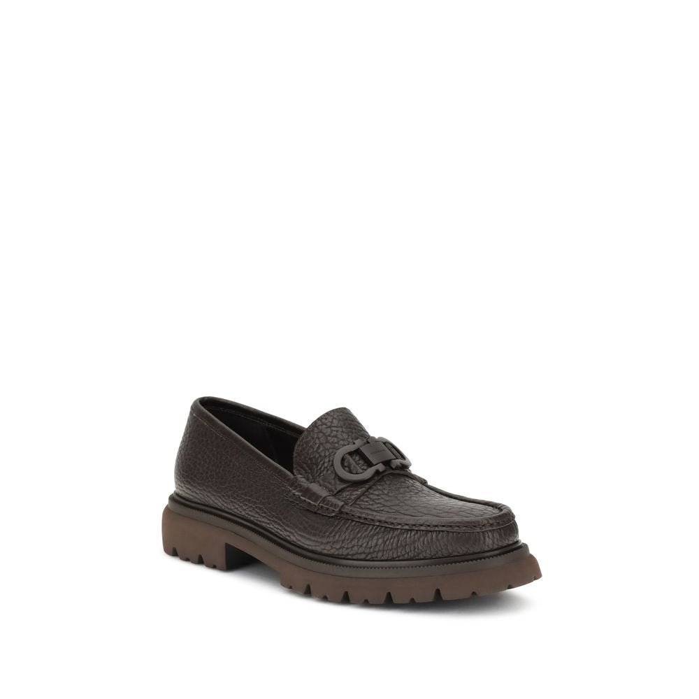 Brown Calf Leather Bos Taurus Slip-On LoafersGancini Loafers by Ferragamo combine craftsmanship and contemporary style. Crafted from washed calfskin, which highlights the natural grain, they feature a rounded toe and an exposed stitching. The tonal buckle