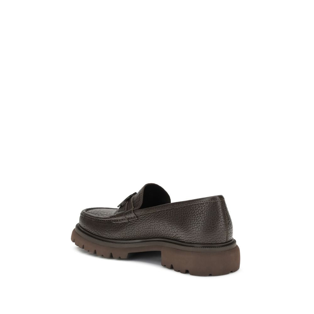 Brown Calf Leather Bos Taurus Slip-On LoafersGancini Loafers by Ferragamo combine craftsmanship and contemporary style. Crafted from washed calfskin, which highlights the natural grain, they feature a rounded toe and an exposed stitching. The tonal buckle