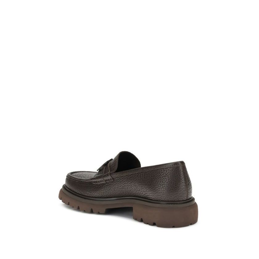 Brown Calf Leather Bos Taurus Slip-On LoafersGancini Loafers by Ferragamo combine craftsmanship and contemporary style. Crafted from washed calfskin, which highlights the natural grain, they feature a rounded toe and an exposed stitching. The tonal buckle