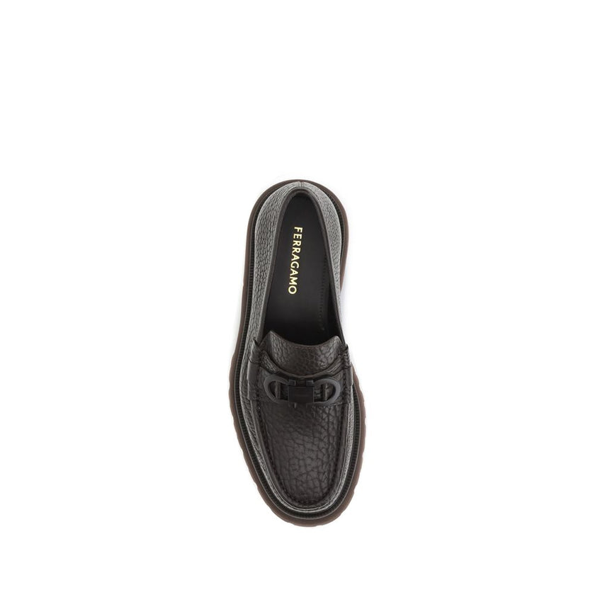 Brown Calf Leather Bos Taurus Slip-On LoafersGancini Loafers by Ferragamo combine craftsmanship and contemporary style. Crafted from washed calfskin, which highlights the natural grain, they feature a rounded toe and an exposed stitching. The tonal buckle