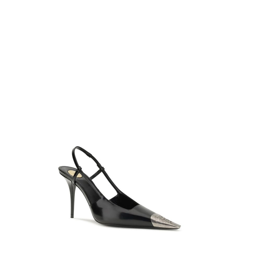Black Calf Leather Bos Taurus PumpsJeanne Pumps by Saint Laurent are distinguished by a square metal toe decorated with a hammered Cassandre motif, which lends a bold and sophisticated touch. The opening at the back is enhanced by the elasticized strap, w