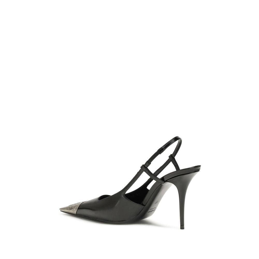Black Calf Leather Bos Taurus PumpsJeanne Pumps by Saint Laurent are distinguished by a square metal toe decorated with a hammered Cassandre motif, which lends a bold and sophisticated touch. The opening at the back is enhanced by the elasticized strap, w