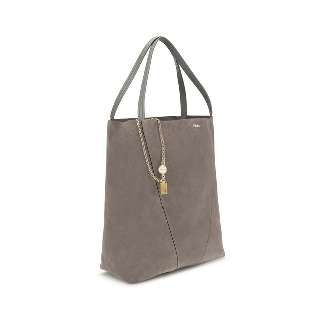 Gray Calf Leather Bos Taurus Shoulder BagThe Spin Tote Bag by Chloé embodies refined, timeless style. Crafted from soft suede calfskin with smooth leather trims, it features a clean, rectangular silhouette defined by minimalist lines. Dual top handles all