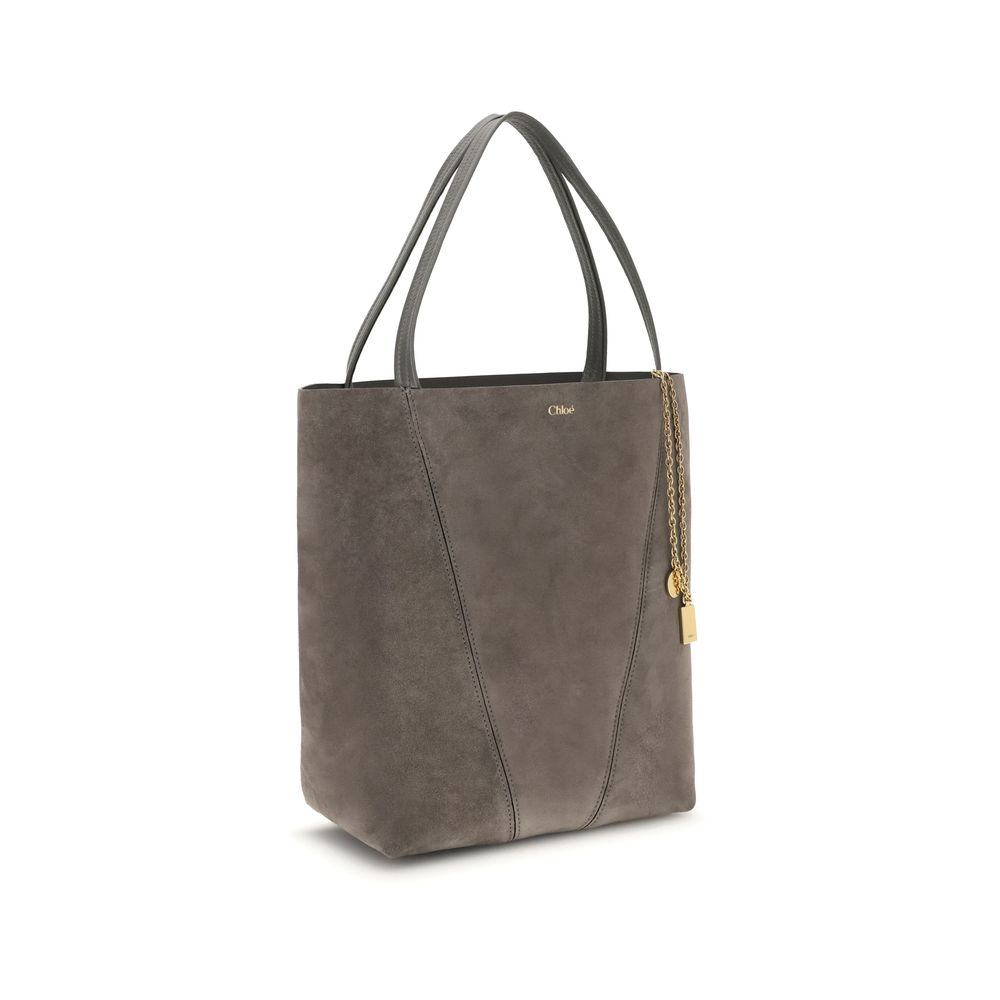 Gray Calf Leather Bos Taurus Shoulder BagThe Chloé Spin Tote Bag in suede combines a minimalist silhouette with iconic details. The two leather handles ensure practicality, while the pendant chain with the Chloé and Horse medals adds a distinctive touch.