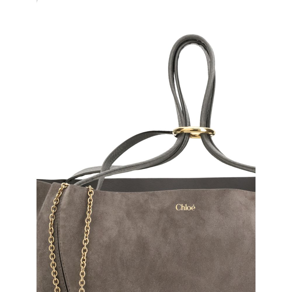Gray Calf Leather Bos Taurus Shoulder BagThe Spin Tote Bag by Chloé embodies refined, timeless style. Crafted from soft suede calfskin with smooth leather trims, it features a clean, rectangular silhouette defined by minimalist lines. Dual top handles all