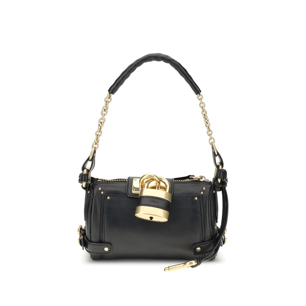 Paddington Shoulder BagPaddington Shoulder Bag by Chloé, crafted from soft garnet buffalo leather, stands out for its compact and flexible silhouette. Featuring a practical top zipper, it is embellished with iconic details such as an oversize padlock, C-s