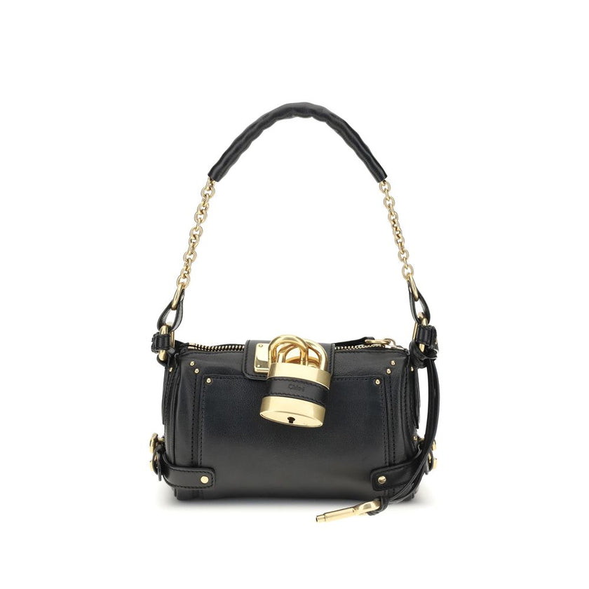 Paddington Shoulder BagPaddington Shoulder Bag by Chloé, crafted from soft garnet buffalo leather, stands out for its compact and flexible silhouette. Featuring a practical top zipper, it is embellished with iconic details such as an oversize padlock, C-s