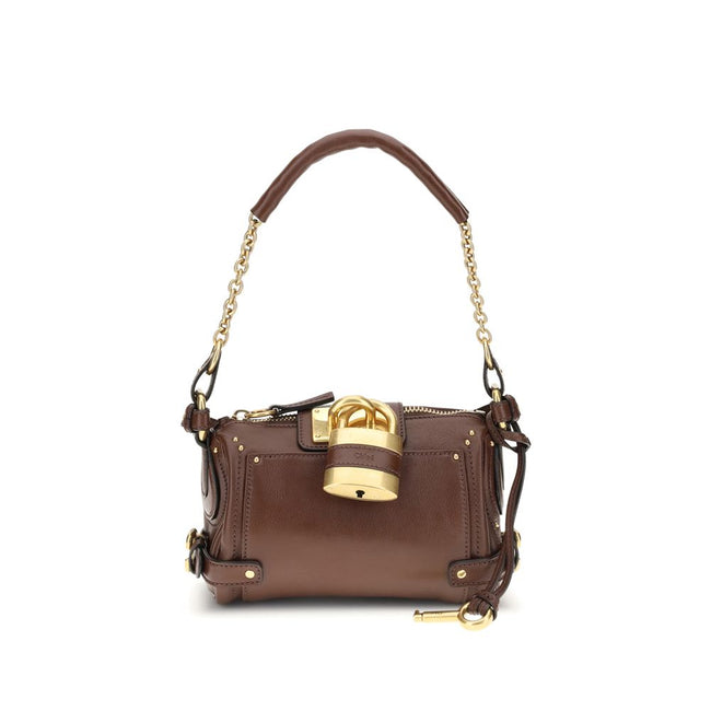 Paddington Shoulder BagPaddington Shoulder Bag by Chloé, crafted from soft garnet buffalo leather, stands out for its compact and flexible silhouette. Featuring a practical top zipper, it is embellished with iconic details such as an oversize padlock, C-s