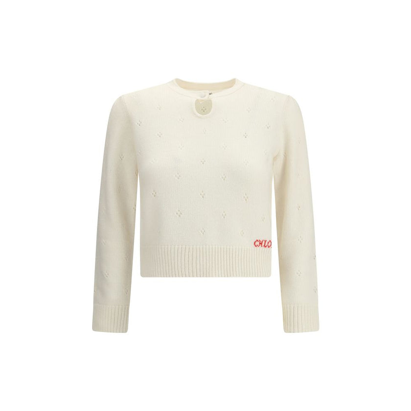 Cream Wool SweatshirtThe Jumper by Chloé blends lightness and refinement with an openwork motif that highlights its ethereal elegance. A buttoned keyhole neck brings a touch of femininity and sophistication, while ribbed trims softly define the silhouette