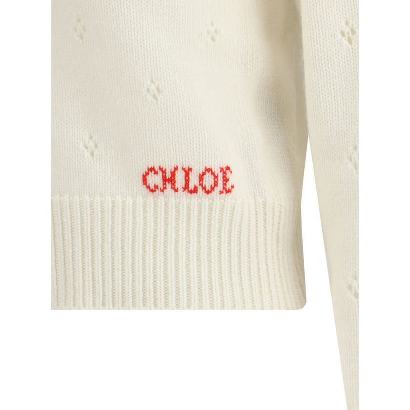 Cream Wool SweatshirtThe Jumper by Chloé blends lightness and refinement with an openwork motif that highlights its ethereal elegance. A buttoned keyhole neck brings a touch of femininity and sophistication, while ribbed trims softly define the silhouette