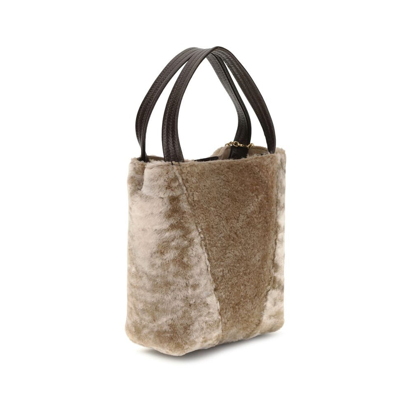 Beige Fur Shoulder BagSpin small Tote Bag by Chloè in soft shearling is distinguished by a compact, minimalist silhouette defined by clean graphic lines. The discreet elegance of the design is enhanced by a dangling chain with the iconic Chloé medals and