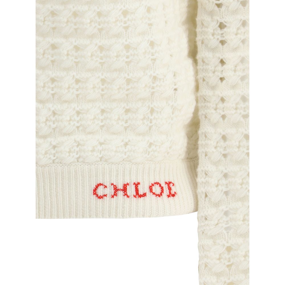 Buttoned-up CardiganThe Chloé Cardigan embodies a delicate, timeless femininity. Its wide sleeves flow from a refined crew neckline, while fabric-covered buttons add a touch of artisanal sophistication. Ribbed trims give the piece structure and definition