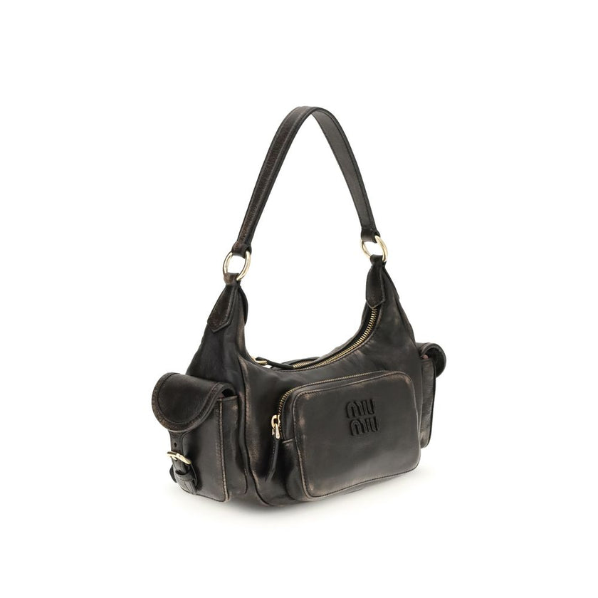 Pocket Shoulder BagThe Pocket Shoulder Bag in nappa leather by Miu Miu combines contemporary design with practical functionality thanks to its numerous pockets. Crafted from nappa leather with a distressed finish, it is enriched with leather details, gold