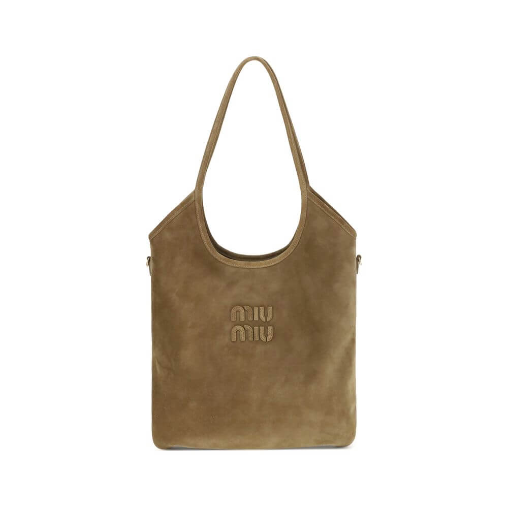 Ivy Shoulder BagThe Ivy Shoulder Bag by Miu Miu combines elegance and practicality in a sophisticated design. Featuring soft suede handles and gold hardware, it’s embellished with a leather logo lettering on the front. The cotton-lined interior includes a