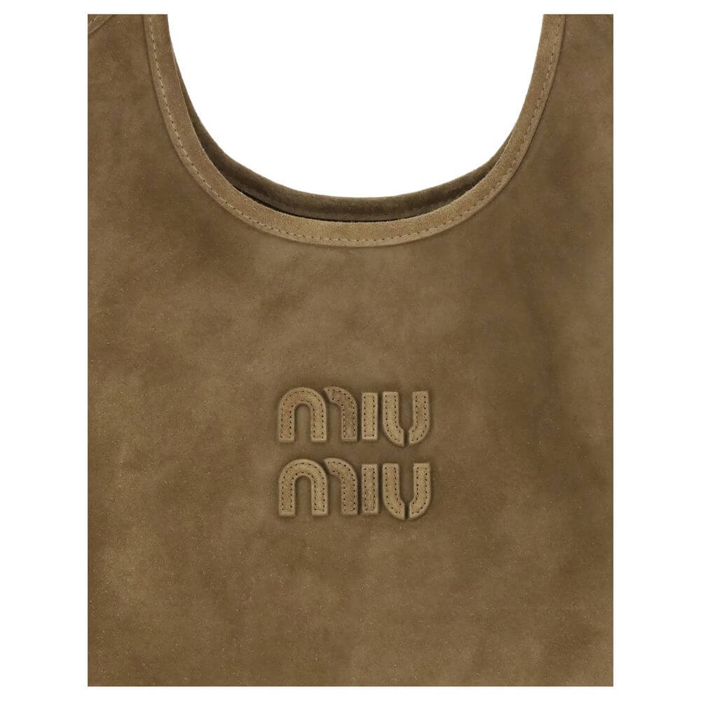 Ivy Shoulder BagThe Ivy Shoulder Bag by Miu Miu combines elegance and practicality in a sophisticated design. Featuring soft suede handles and gold hardware, it’s embellished with a leather logo lettering on the front. The cotton-lined interior includes a