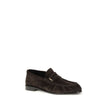 Le Loafer LoafersThe Le Loafer Loafers by Saint Laurent are crafted from soft suede and stand out for their hand-stitched moc toe and iconic gold-tone CASSANDRE decoration. Elegant and refined, they feature a leather sole that highlights their artisanal q