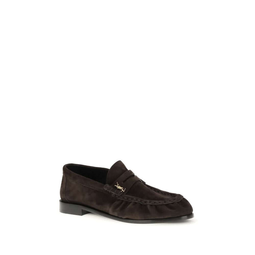 Le Loafer LoafersThe Le Loafer Loafers by Saint Laurent are crafted from soft suede and stand out for their hand-stitched moc toe and iconic gold-tone CASSANDRE decoration. Elegant and refined, they feature a leather sole that highlights their artisanal q