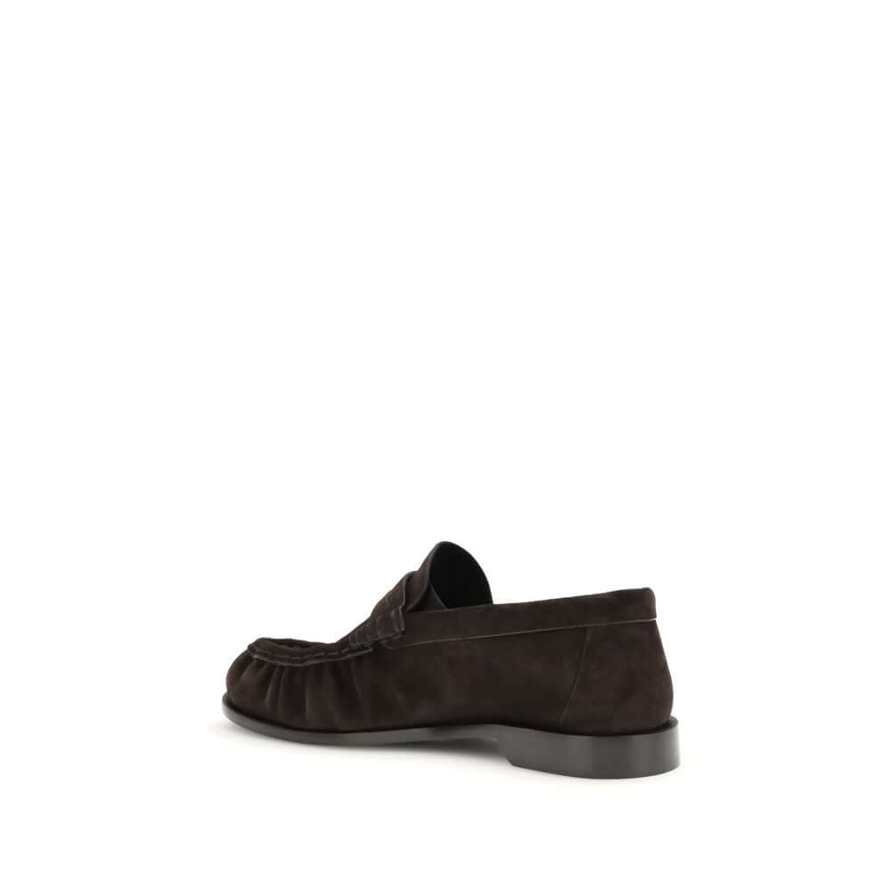 Le Loafer LoafersThe Le Loafer Loafers by Saint Laurent are crafted from soft suede and stand out for their hand-stitched moc toe and iconic gold-tone CASSANDRE decoration. Elegant and refined, they feature a leather sole that highlights their artisanal q