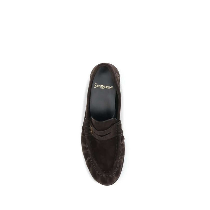 Le Loafer LoafersThe Le Loafer Loafers by Saint Laurent are crafted from soft suede and stand out for their hand-stitched moc toe and iconic gold-tone CASSANDRE decoration. Elegant and refined, they feature a leather sole that highlights their artisanal q