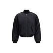 Black Polyamide BomberThe Standard Bomber offers a refined take on a timeless staple. Crafted from recycled satin-finish polyamide, it features ruched sleeves that add volume and character to the silhouette. A central zip closure and ribbed trims highligh