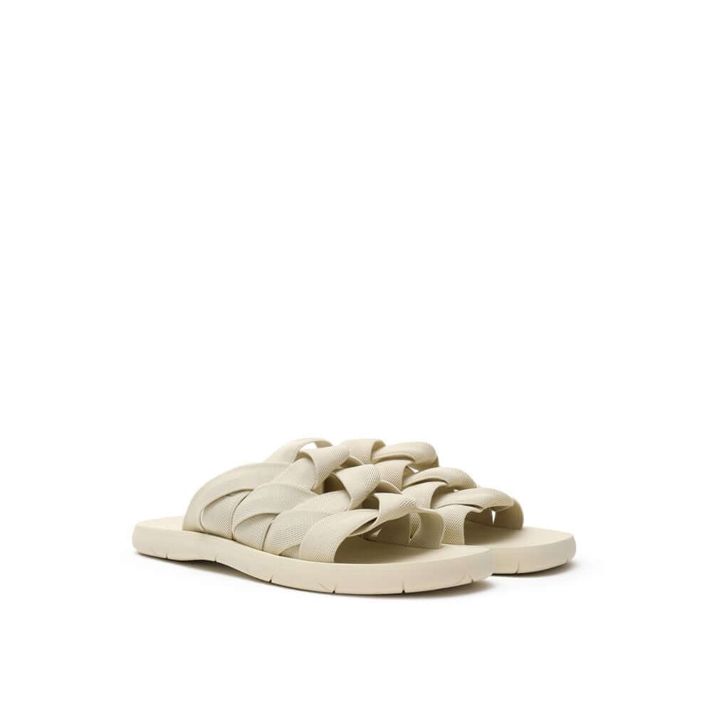 Beige Fabric SlippersBottega Veneta Beige Elastic Woven Rubber Slipper Sandals. In sand beige, rounded rubber sole, tone-on-tone elastic weave. Composition: Technical fabric, rubber. Internal SKU: 25OTT04 Brand SKU: 651402V0GV09031Beige Fabric Slippers${t