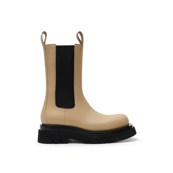 Beige Leather Chelsea BootsBeige and Black Leather Lug Ankle Boots by Bottega Veneta. Maxi black lug sole, round toe, brushed leather, contrasting elastic side bands, and shoehorn tabs on the front and back for comfortable wear. Composition: Leather Inter