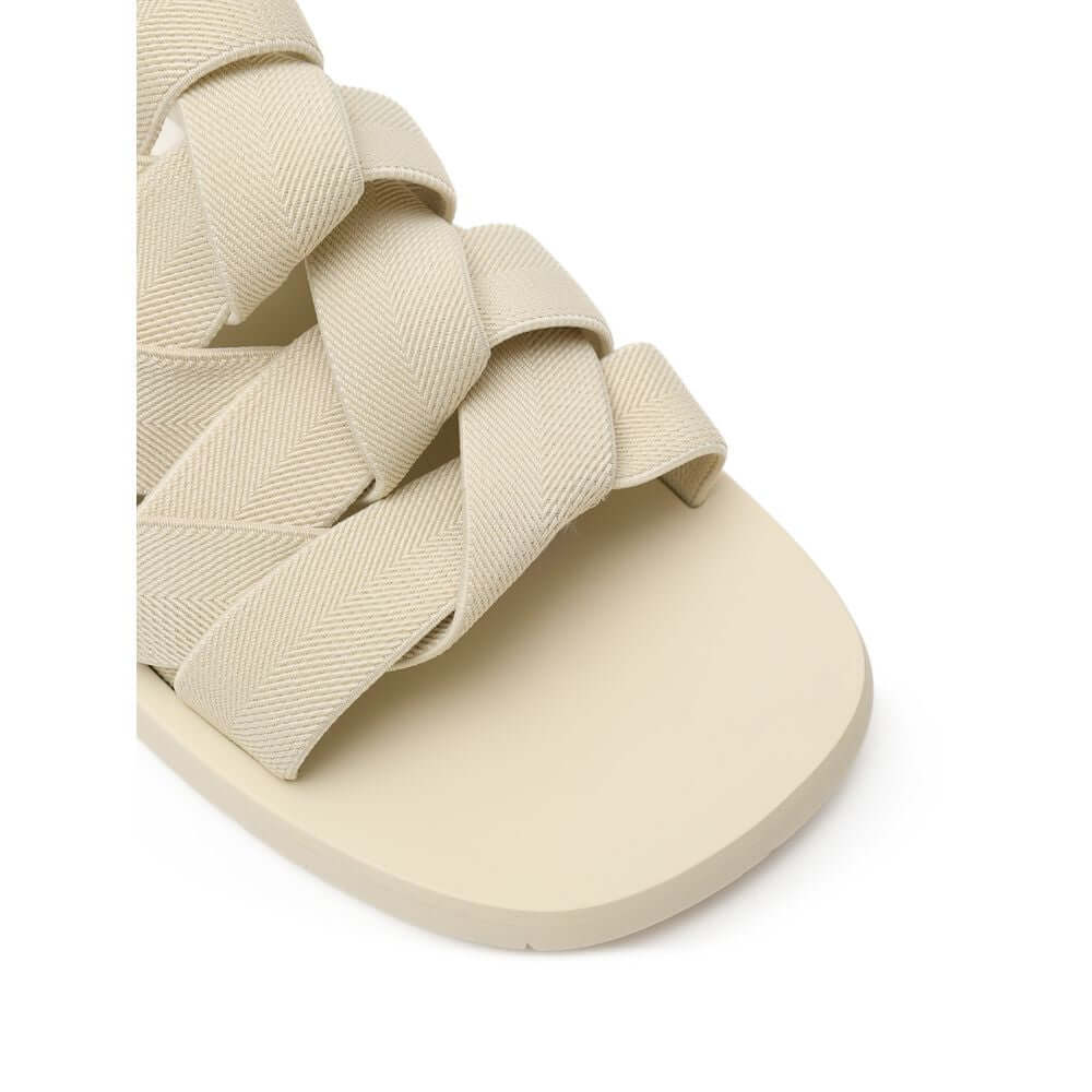 Beige Fabric SlippersBottega Veneta Beige Elastic Woven Rubber Slipper Sandals. In sand beige, rounded rubber sole, tone-on-tone elastic weave. Composition: Technical fabric, rubber. Internal SKU: 25OTT04 Brand SKU: 651402V0GV09031Beige Fabric Slippers${t