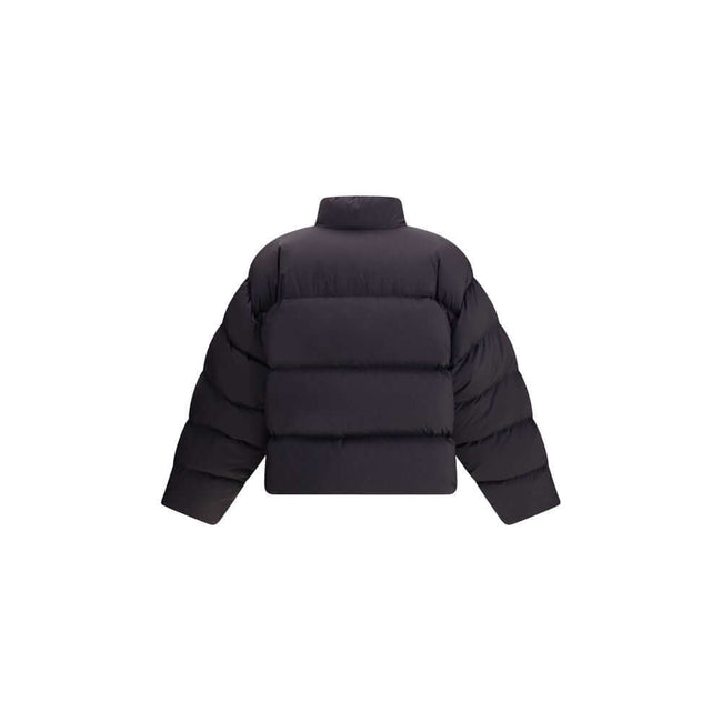 Black Polyamide ClothingThe Balenciaga Standard Puffer in Black is a contemporary wardrobe essential. Crafted from lightweight matte nylon, it features a cocoon-like volume, high straight collar, concealed zip with snap-button placket, two slanted pockets
