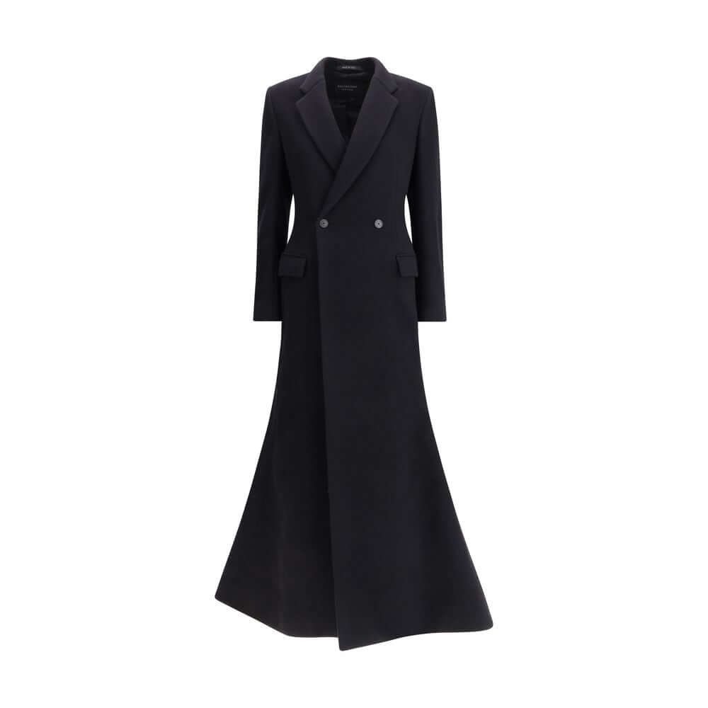 Black Wool CoatThe oversized double-breasted Coat by Balenciaga is an icon of contemporary elegance, blending sartorial precision with bold proportions. Crafted from a luxurious black wool and cashmere blend, it features a wide, structured silhouette enha