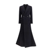 Black Wool CoatThe oversized double-breasted Coat by Balenciaga is an icon of contemporary elegance, blending sartorial precision with bold proportions. Crafted from a luxurious black wool and cashmere blend, it features a wide, structured silhouette enha