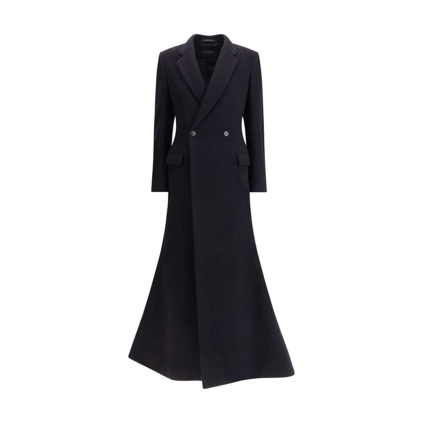 Black Wool CoatThe oversized double-breasted Coat by Balenciaga is an icon of contemporary elegance, blending sartorial precision with bold proportions. Crafted from a luxurious black wool and cashmere blend, it features a wide, structured silhouette enha