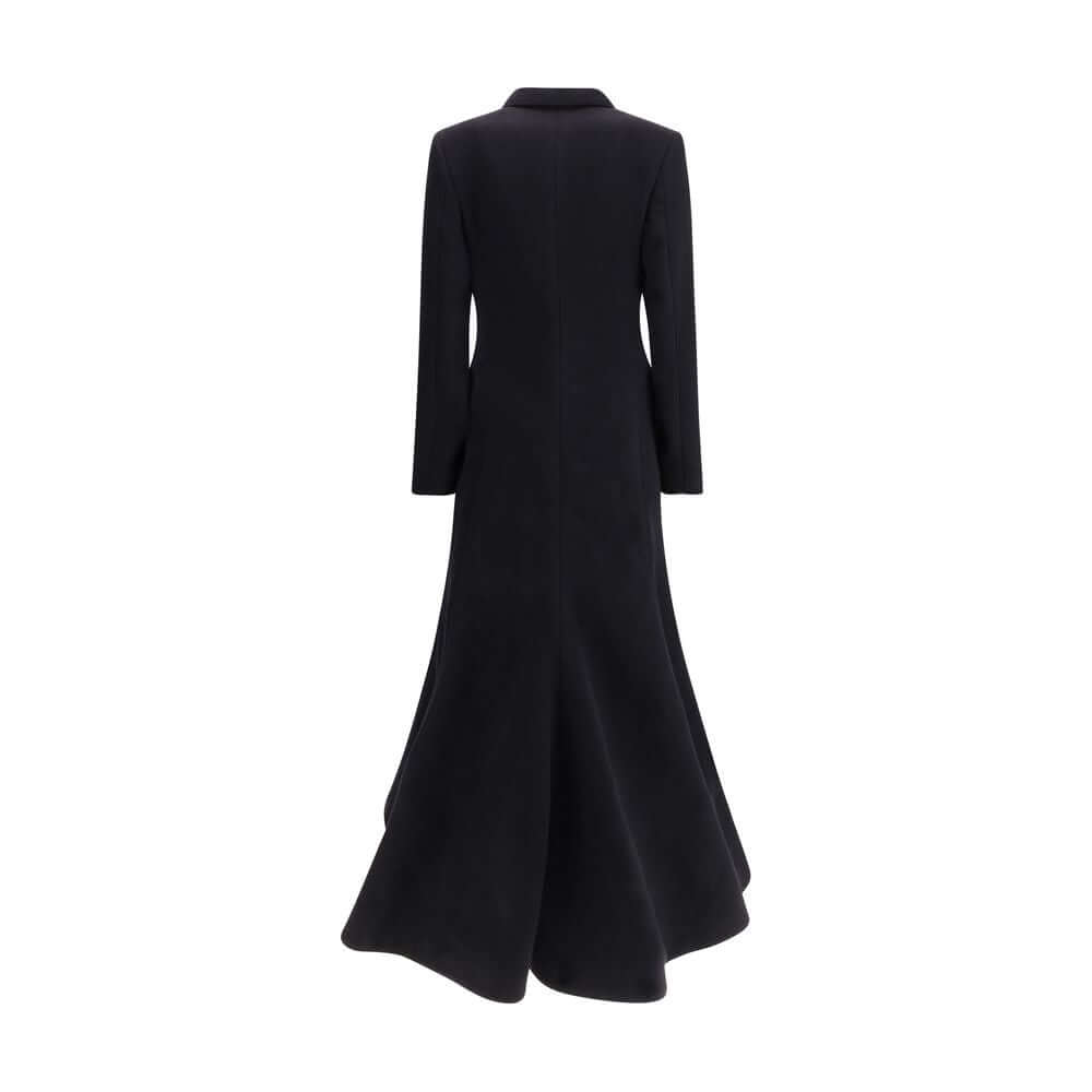 Black Wool CoatThe oversized double-breasted Coat by Balenciaga is an icon of contemporary elegance, blending sartorial precision with bold proportions. Crafted from a luxurious black wool and cashmere blend, it features a wide, structured silhouette enha