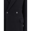 Black Wool CoatThe oversized double-breasted Coat by Balenciaga is an icon of contemporary elegance, blending sartorial precision with bold proportions. Crafted from a luxurious black wool and cashmere blend, it features a wide, structured silhouette enha