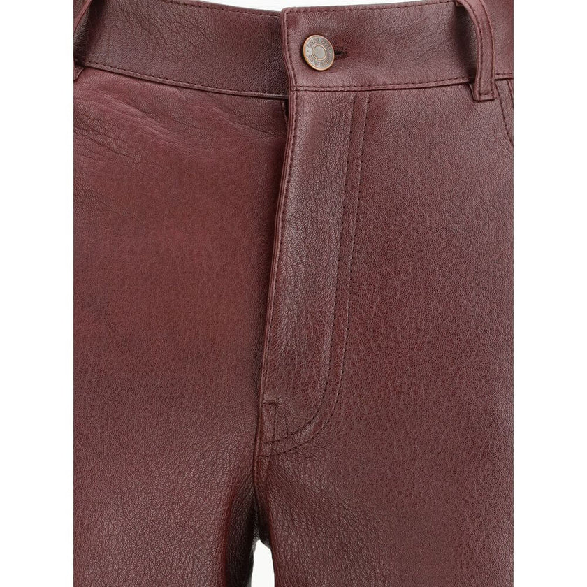 Bordeaux Leather PantsThe flared lambskin leather trousers by Chloé, crafted from slightly textured leather for a refined and distinctive look. Featuring a front zip and logo-engraved button closure, belt loops and a classic five-pocket design. An iconic