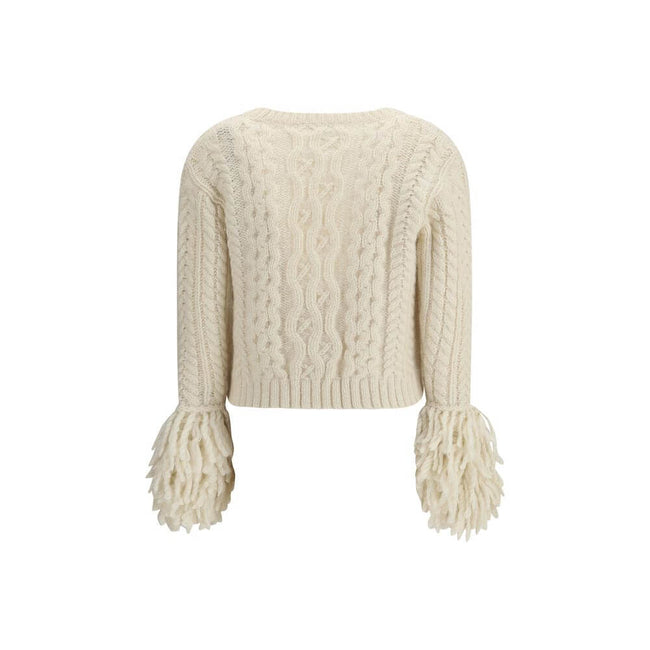 Cream Alpaca Vicugna Pacos CardiganThe V-neck cardigan by Moncler is reimagined with a contemporary twist through refined textures. Crafted from a luxurious blend of nylon, wool, alpaca, and mohair, it features a distinctive cable and Aran knit that adds