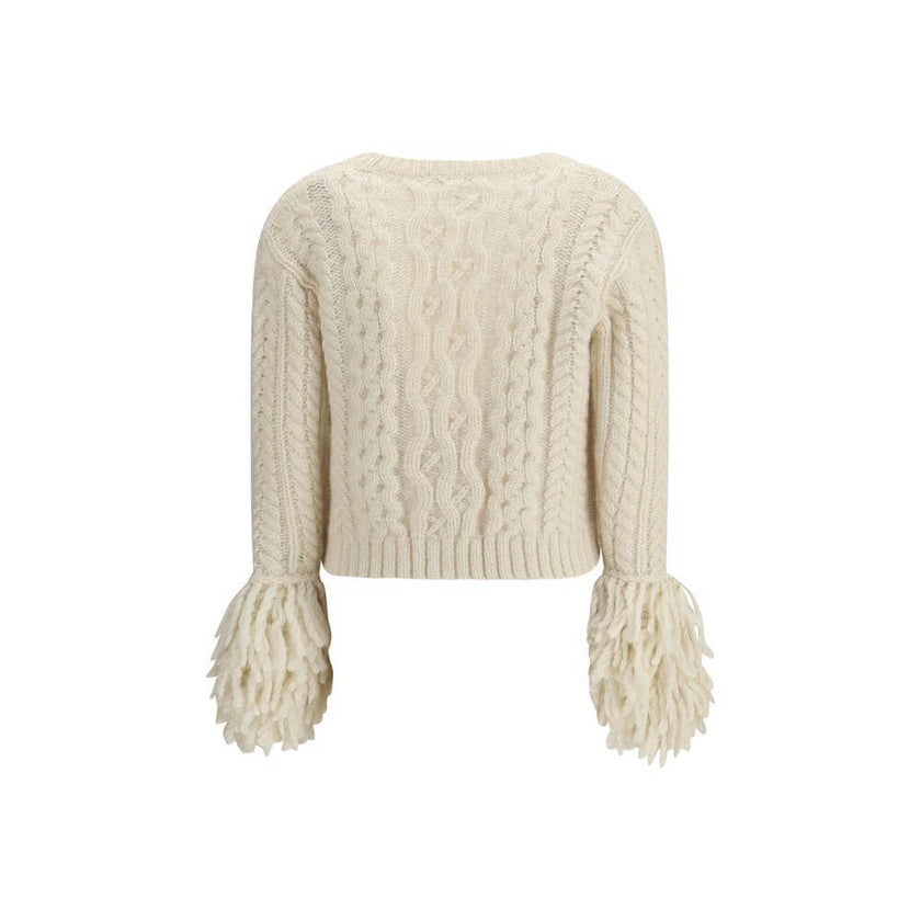 Cream Alpaca Vicugna Pacos CardiganThe V-neck cardigan by Moncler is reimagined with a contemporary twist through refined textures. Crafted from a luxurious blend of nylon, wool, alpaca, and mohair, it features a distinctive cable and Aran knit that adds